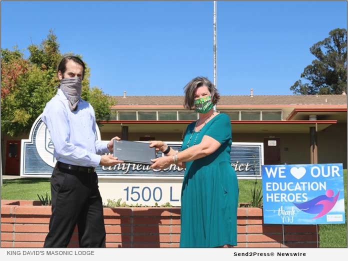 Andrew Brown Delivers laptops to SLCUSD