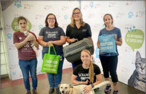 Staff from the Sacramento SPCA gather with pets and the Adoption Success Kits